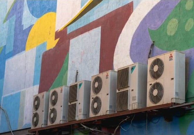 Mitsubishi and Daikin outdoor units installed on a commercial wall